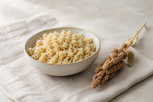 A bowl of cooked quinoa with a quinoa seed head